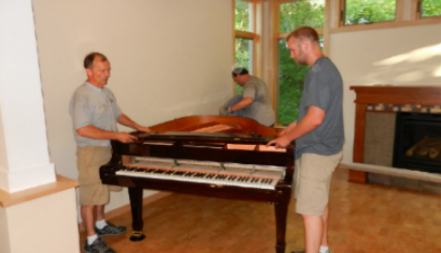 two man moving a piano
